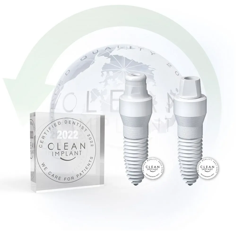 Two white ceramic dental implants beside a glass Clean Implant certified dentist 2022 award block
