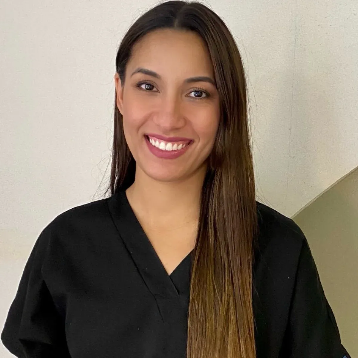 Cindy Yoheni Sousa smiling, in black scrubs